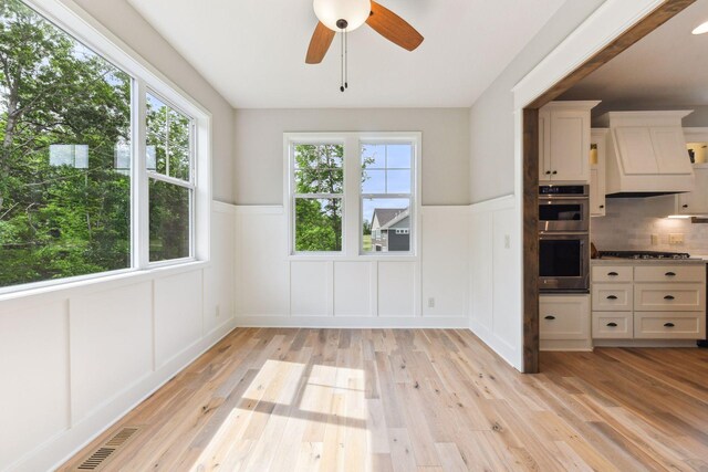 interior space with ceiling fan and light hardwood / wood-style flooring