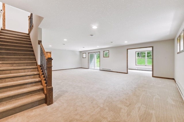 unfurnished living room with a baseboard radiator, light carpet, and a textured ceiling