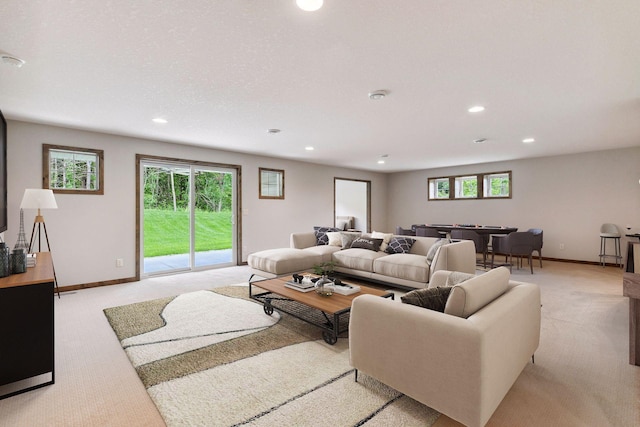 living room featuring light carpet and plenty of natural light