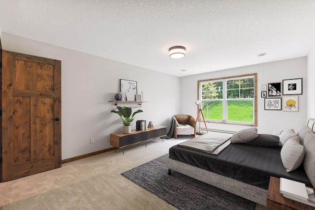 bedroom featuring a textured ceiling and light colored carpet