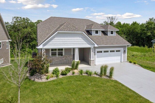 view of front of home featuring a garage and a front lawn