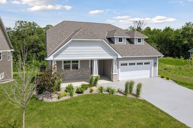 view of front of home with a front lawn and a garage