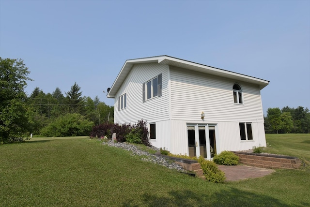 rear view of house with a yard and french doors