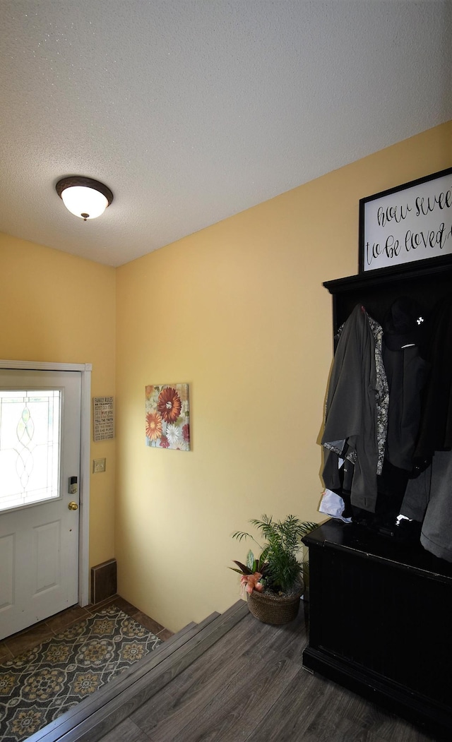 mudroom featuring a textured ceiling and wood finished floors