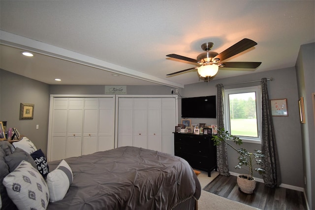 bedroom featuring multiple closets, wood finished floors, baseboards, recessed lighting, and a ceiling fan