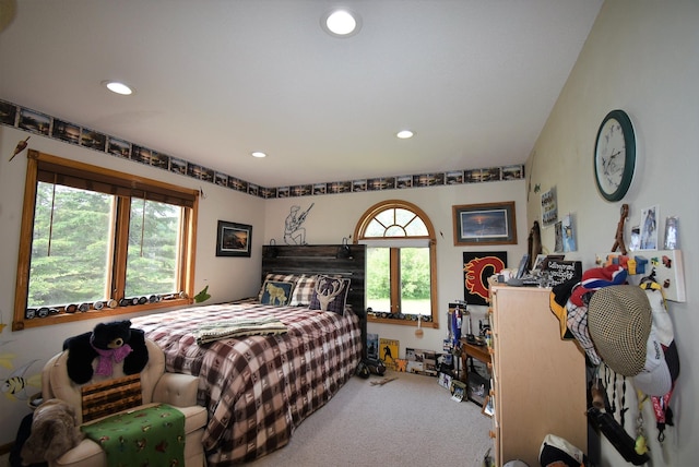 carpeted bedroom with recessed lighting and multiple windows