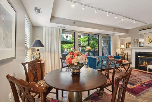 dining room featuring light wood-type flooring and rail lighting