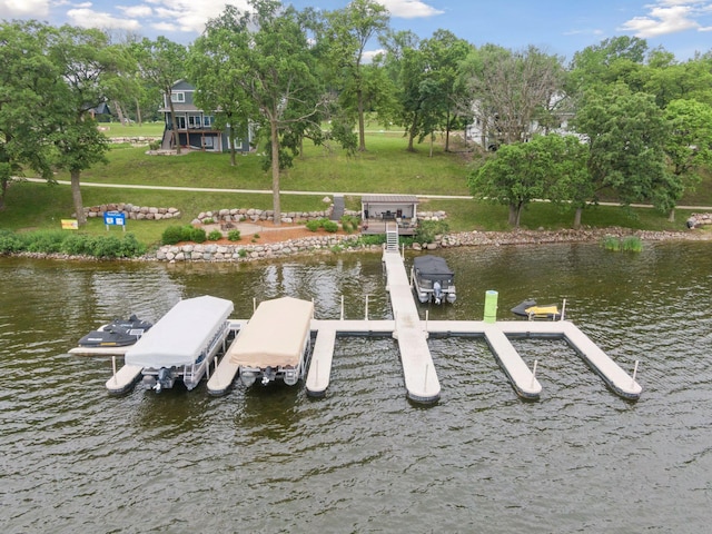 view of dock featuring a yard and a water view