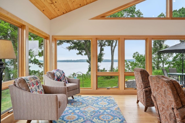 sunroom / solarium featuring vaulted ceiling, wood ceiling, a water view, and plenty of natural light