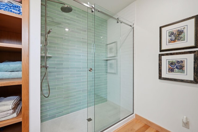 bathroom with walk in shower and hardwood / wood-style flooring