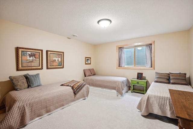 bedroom featuring a textured ceiling and carpet floors