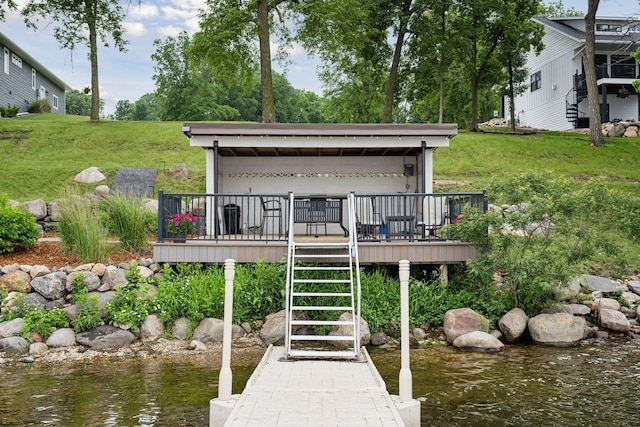 dock area featuring a deck with water view and a lawn