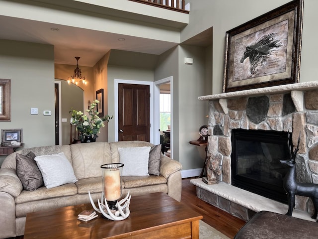 living room with a stone fireplace and hardwood / wood-style floors