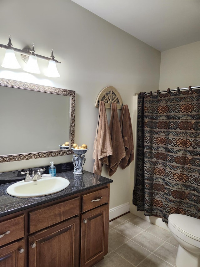 bathroom featuring vanity, tile patterned floors, and toilet