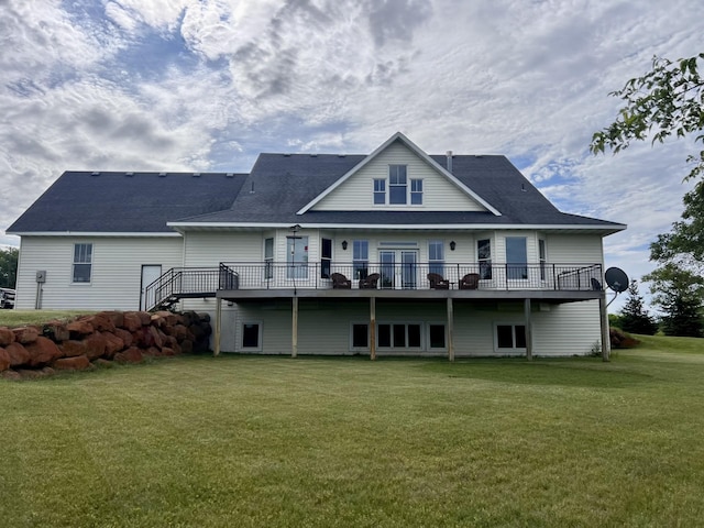 back of house featuring a wooden deck and a yard