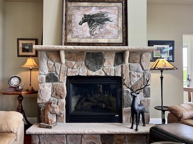 details featuring a fireplace and baseboards