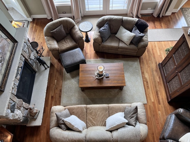 living area with a fireplace and wood finished floors