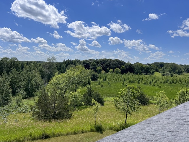 view of landscape with a forest view