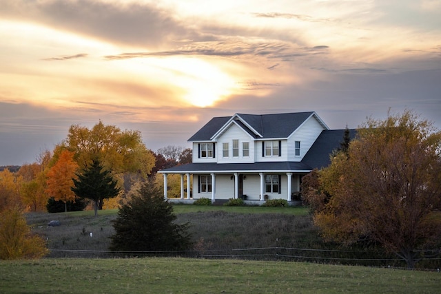 20801 13th Ave, Saint Augusta, MN 55320 - farmhouse-style home featuring a porch and a lawn