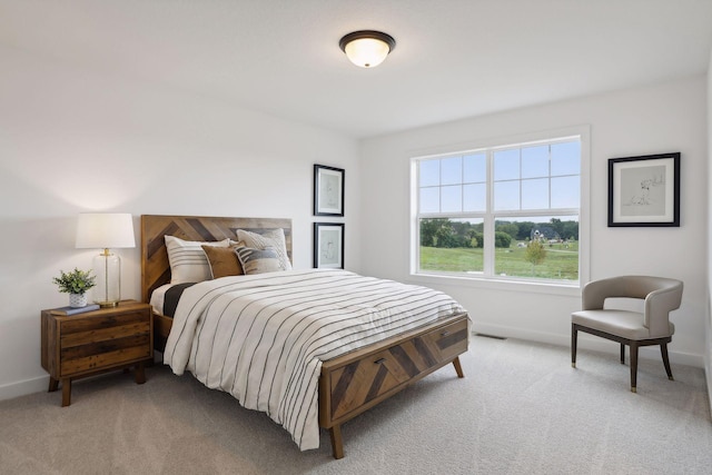 bedroom featuring light carpet