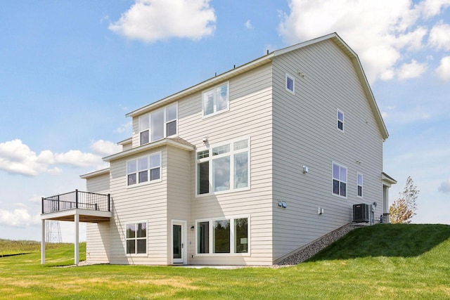 back of house featuring a wooden deck, a yard, and central air condition unit