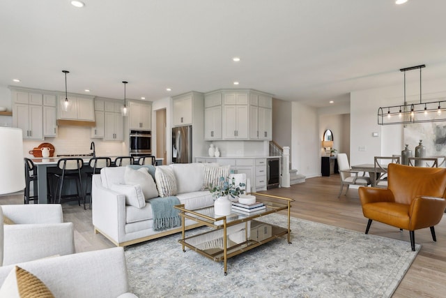 living room featuring beverage cooler and light wood-type flooring