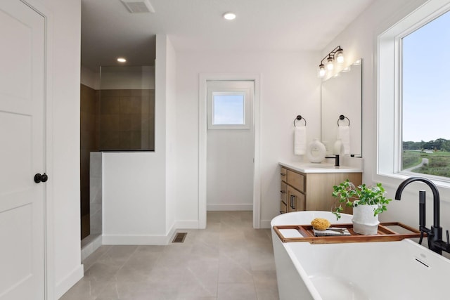 bathroom featuring plenty of natural light, tile patterned floors, vanity, and separate shower and tub