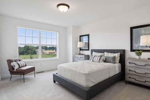 carpeted bedroom featuring multiple windows