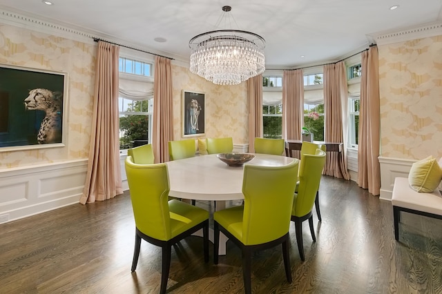 dining room with dark hardwood / wood-style flooring, crown molding, and a chandelier