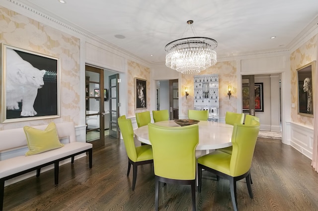 dining area with ornamental molding, an inviting chandelier, dark hardwood / wood-style flooring, and french doors