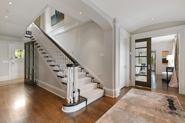 entryway featuring vaulted ceiling and dark hardwood / wood-style floors