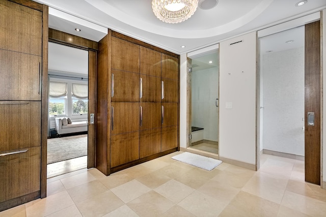 foyer entrance with a raised ceiling