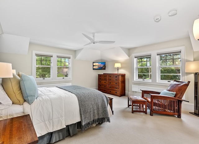 bedroom featuring multiple windows, light carpet, and ceiling fan