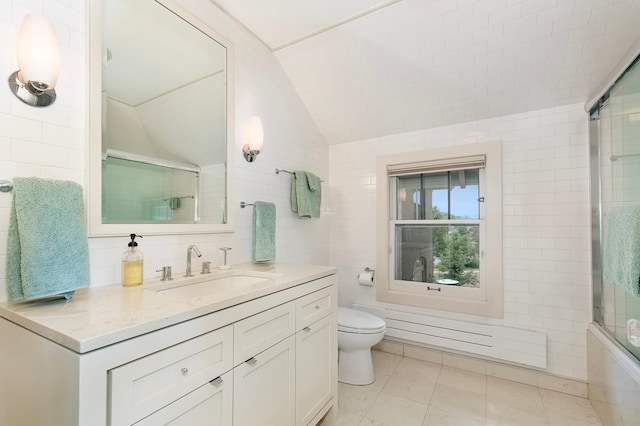 full bathroom featuring lofted ceiling, tile walls, vanity, tile patterned floors, and toilet