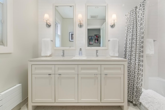 bathroom with shower / bathtub combination with curtain, vanity, and tasteful backsplash