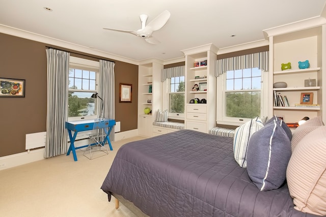 carpeted bedroom with crown molding and ceiling fan