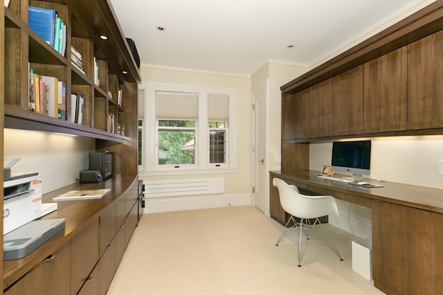 office area with light carpet, built in desk, and ornamental molding