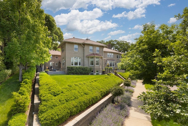 rear view of property featuring a yard