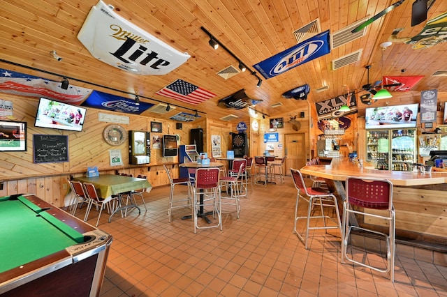 26490 Freedom Valley Dr, Bayview Twp, WI 54891 - game room with lofted ceiling, bar, pool table, wooden ceiling, and wood walls