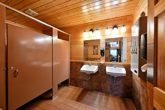 26490 Freedom Valley Dr, Bayview Twp, WI 54891 - bathroom featuring tile patterned flooring, sink, wooden walls, and wood ceiling