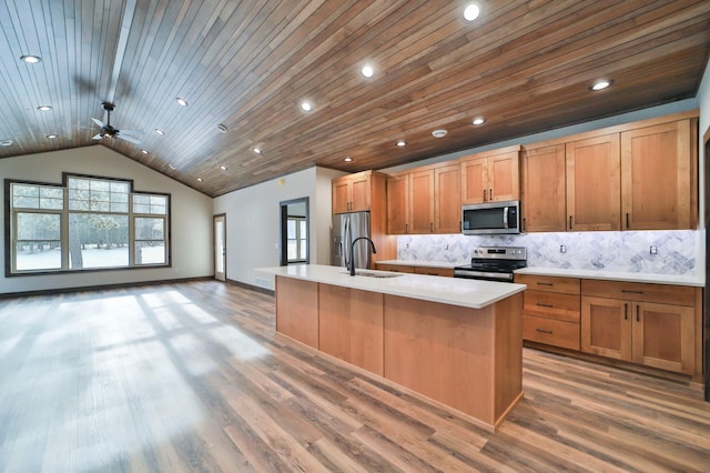 kitchen featuring tasteful backsplash, stainless steel appliances, hardwood / wood-style flooring, wooden ceiling, and an island with sink