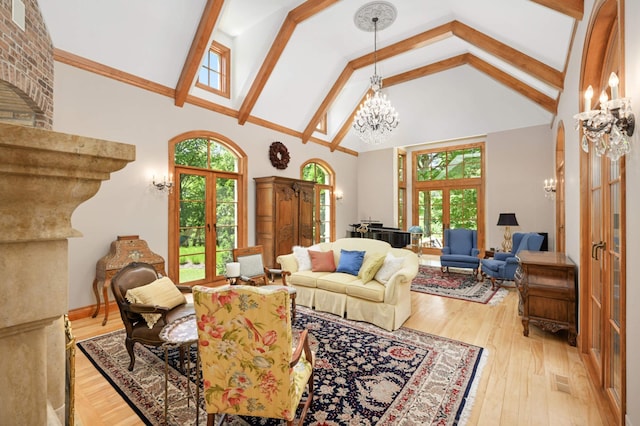 living room with french doors, high vaulted ceiling, an inviting chandelier, and light hardwood / wood-style floors