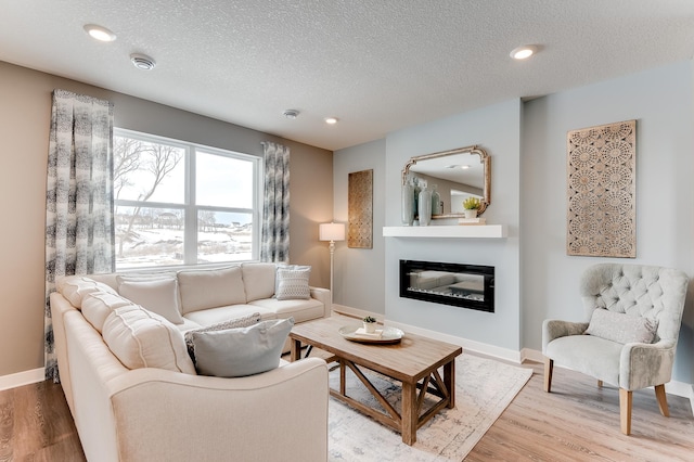 living room featuring a textured ceiling and hardwood / wood-style flooring