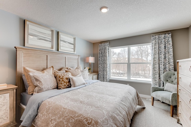 carpeted bedroom featuring a textured ceiling