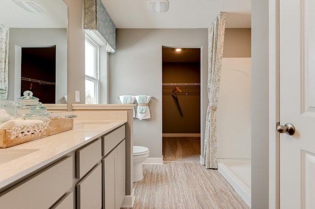 bathroom with toilet, hardwood / wood-style floors, vanity, and a shower with shower curtain