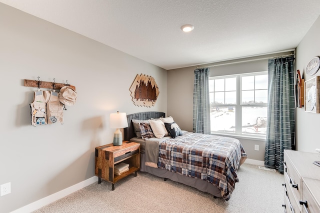 carpeted bedroom with a textured ceiling