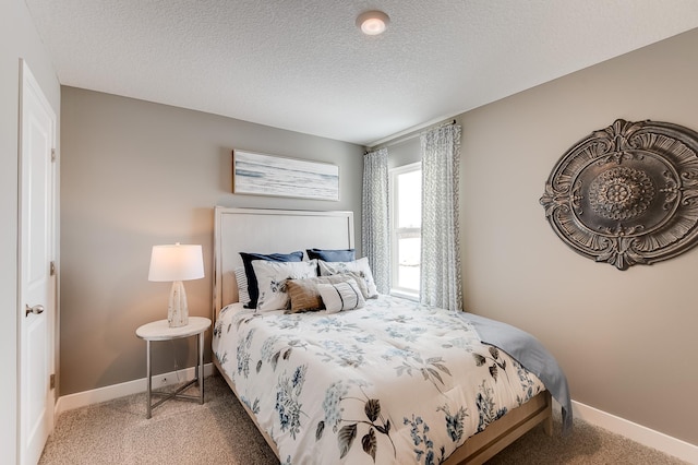 carpeted bedroom with a textured ceiling