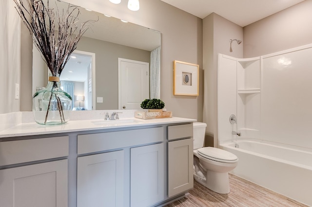 full bathroom featuring vanity, toilet, wood-type flooring, and shower / washtub combination