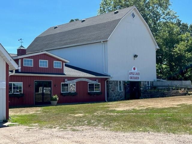 back of property featuring a yard