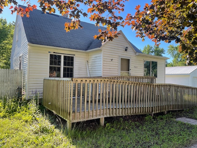 rear view of house featuring a wooden deck